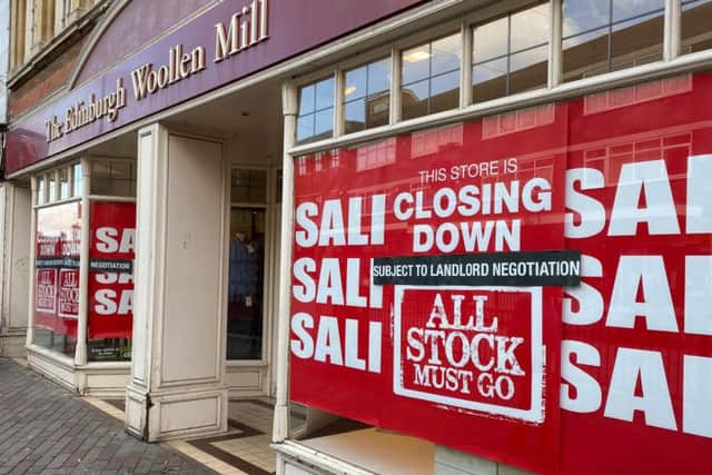 'Closing down' signs in the windows of Edinburgh Woollen Mill in Abington Street, Northampton