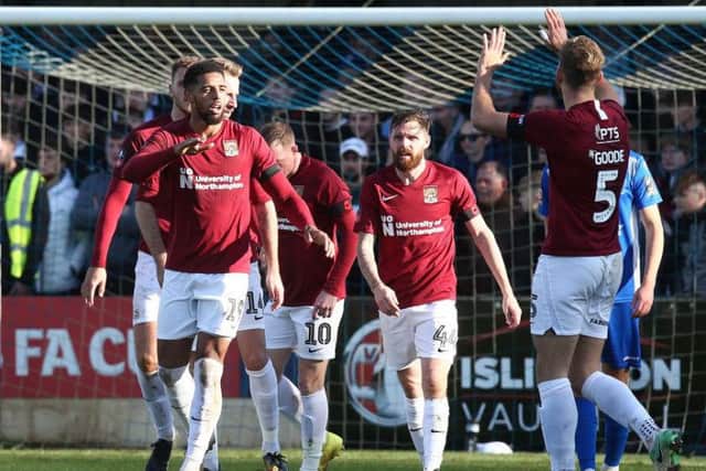 Vadaine Oliver takes the plaudits after scoring his first goal for the Cobblers, heading home Nicky Adams' cross 25 minutes into Sunday's tie. Pictures: Pete Norton