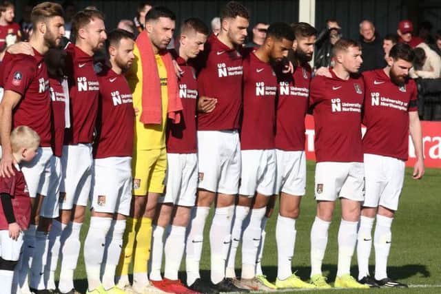 Cobblers pause for a moment of silence on Remembrance Sunday. Pictures: Pete Norton