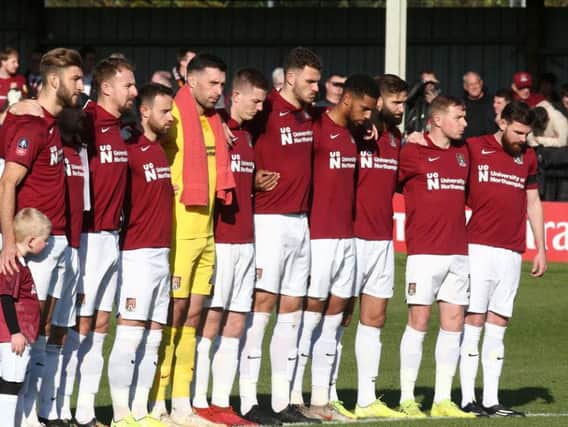 Cobblers pause for a moment of silence on Remembrance Sunday. Pictures: Pete Norton