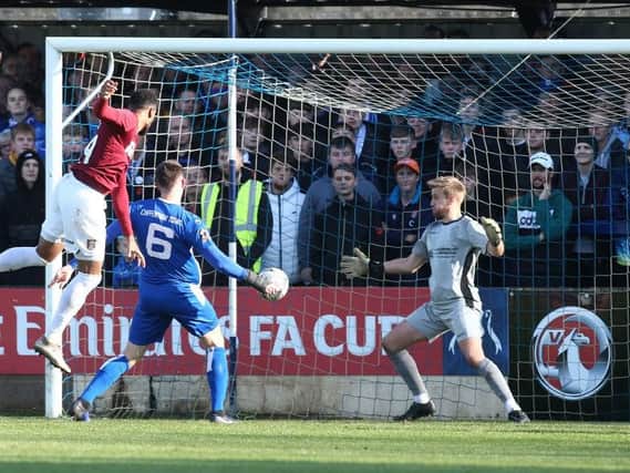 Vadaine Oliver rose high to head home Nicky Adams' cross and score his first goal for the Cobblers on Sunday. Picture: Pete Norton