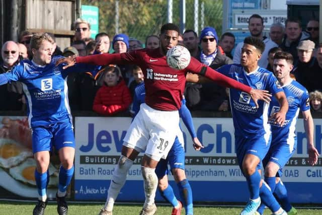 Surrounded: Vadaine Oliver fends off four defenders