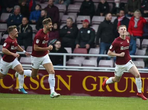 Scott Wharton celebrates his first goal for the Cobblers, one of two in the first-half against Crewe. Picture: Pete Norton