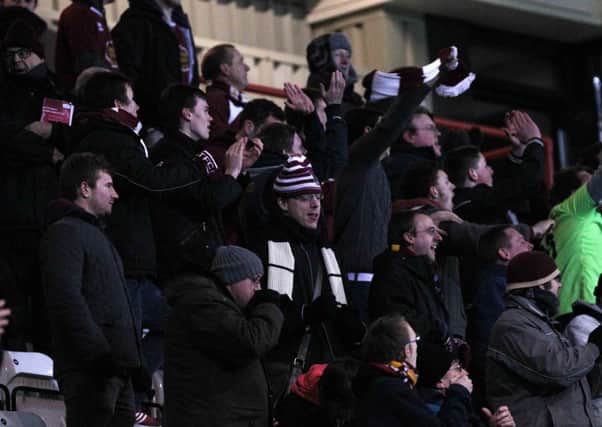 PLAYING THEIR PART - a section of the Cobblers' travelling support at Morecambe on Tuesday
