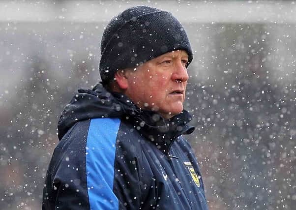 NOT HAPPY - Oxford United boss Chris Wilder watches his team lose to Cobblers in the snow at Sixfields (Picture: Sharon Lucey)