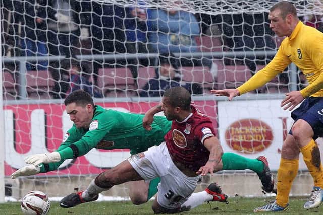 SAFE HANDS - Cobblers goalkeeper Lee Nicholls tries to gather a loose ball in Saturday's 1-0 win over Oxford United (Picture: Sharon Lucey)
