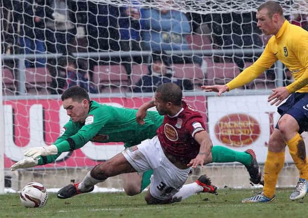 SAFE HANDS - Cobblers goalkeeper Lee Nicholls tries to gather a loose ball in Saturday's 1-0 win over Oxford United (Picture: Sharon Lucey)