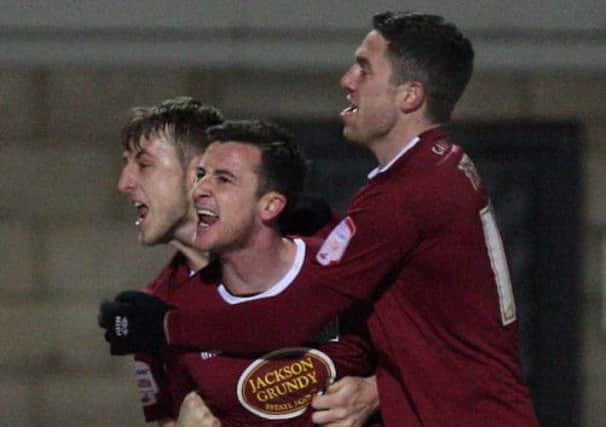 LATE SHOW! - John Johnson (left) and Ben Tozer (right) are first on the scene to congratulate scorer Roy O'Donovan at Sixfields on Friday (Picture: Kelly Cooper)