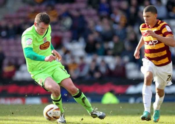 BEST OF A BAD BUNCH - Lee Collins keeps the ball away from Nahki Wells at Valley Parade on Saturday (Picture: Kirsty Edmonds)