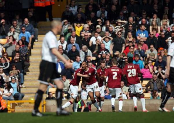 SILENCING THE CROWD - the Cobblers players celebrate Clarke Carlisle's opener at Port Vale (Picture: Kelly Cooper)