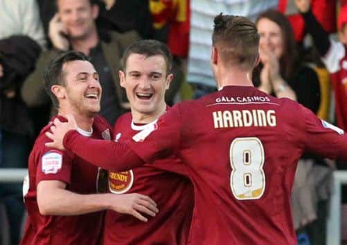 Roy O'Donovan is congratulated after putting the Cobblers ahead against Cheltenham (pictures: Kirsty Edmonds)