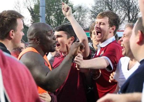 LEAGUE ONE AMBITION - Adebayo Akinfenwa celebrates with the Cobblers fans after the game at Cheltenham (Picture: Sharon Lucey)