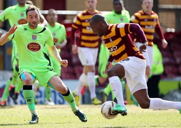 WING MEN - Kyel Reid takes on Cobblers' Chris Hackett at Valley Parade last month