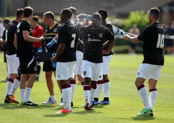 SCORCHER - Roy O'Donovan 'treats' his Cobblers team-mates to an impromptu cold shower in the heat at Sileby Rangers