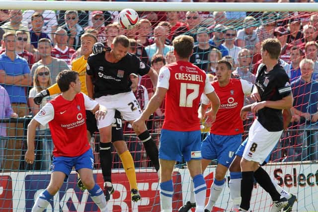 HEADS YOU WIN - Matt Heath heads away the danger as Richard Cresswell looks on (picture: Sharon Lucey)