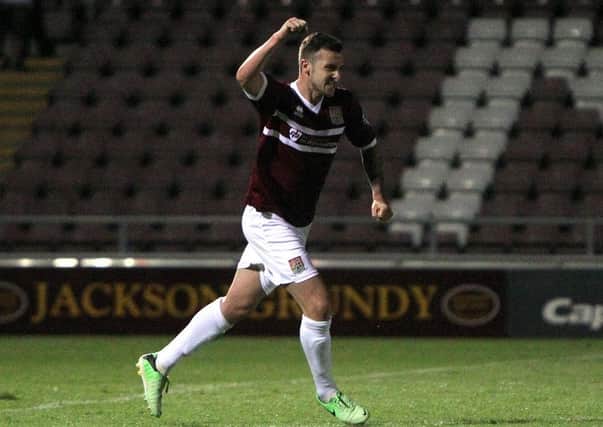 Roy O'Donovan celebrates his goal against MK Dons at Sixfields on Tuesday night (pictures: Tony Waugh)
