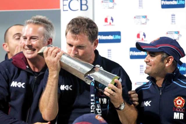 Steelbacks head coach David Ripley gives the Friends Life t20 trophy a kiss after victory over Surrey