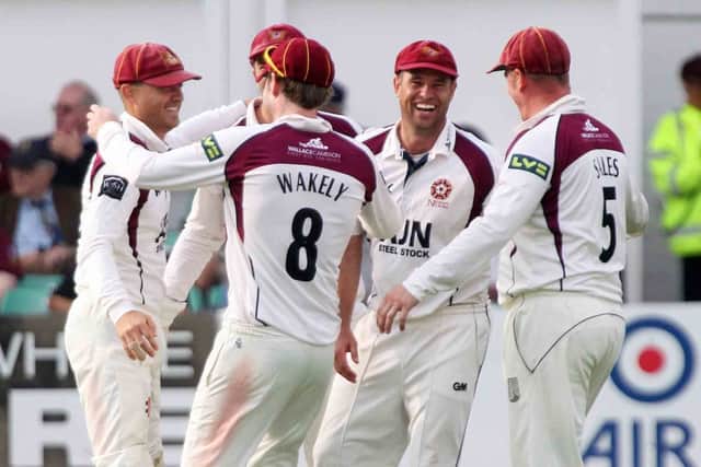 Stephen Peters (left) celebrates with some of his colleagues after promotion was confirmed