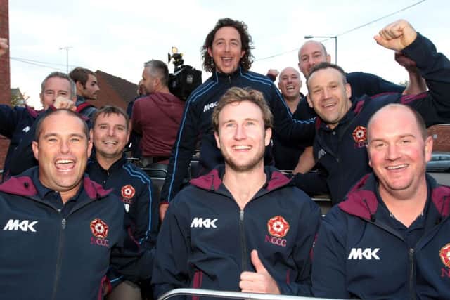 VICTORY PARADE - the Northants players and coaching staff enjoy their open top bus parade in Northampton last weekend