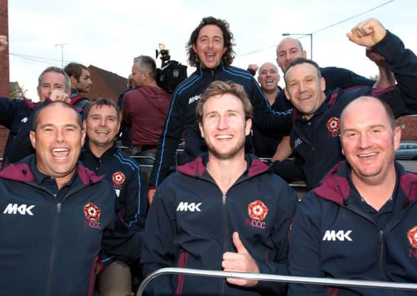 VICTORY PARADE - the Northants players and coaching staff enjoy their open top bus parade in Northampton last weekend