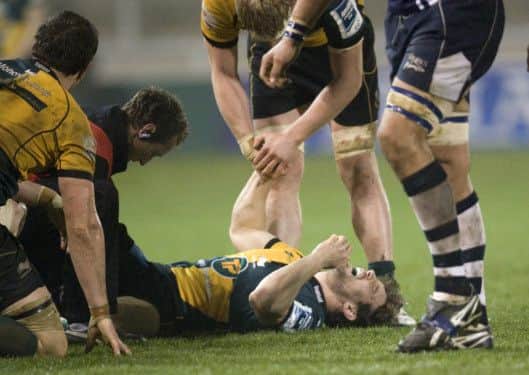 HELPING HAND - Ben Nutley comforts Dom Waldouck after the centre suffered a painful injury at Sale (Picture: Linda Dawson)