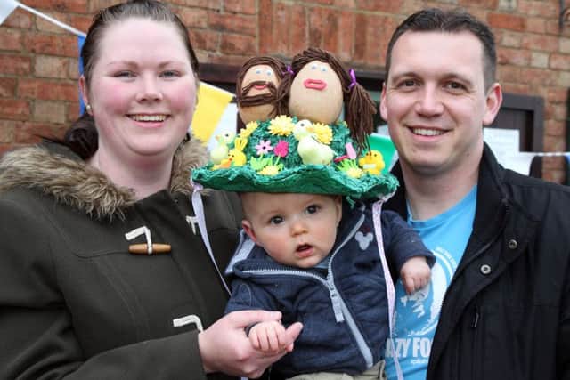 Easter Egg hunt and Easter Bonnet competition at Daventry Country Park. Pictured, Elliott Cooper puts on the winning bonnet with mum Emma and dad Matt
