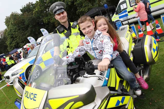 Northamptonshire Police and Northamptonshire Fire Service joint open day at Wootton Hall. 
PC Dave Lee with Brandon Payne, 8 and Chloe Payne, 6.