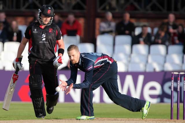 Northamptonshire's new signing Josh Cobb watches on as Graeme White fields the ball