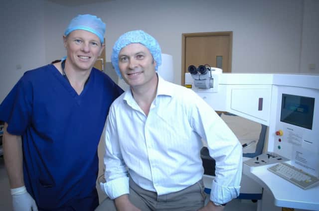 Consultant Opthalmologist Mark Wevill (in scrubs) with Greg Pawsey.