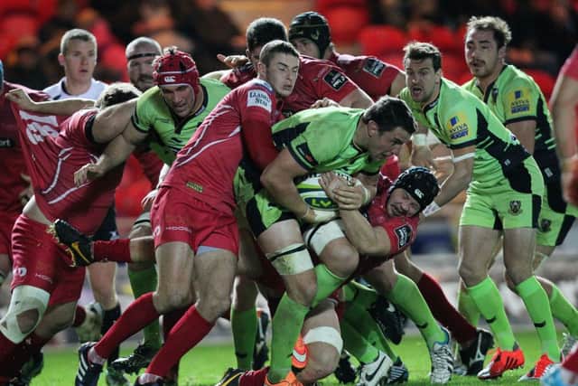 Scarlets get to grips with Phil Dowson during Friday night's LV= Cup clash at Parc y Scarlets (pictures: Sharon Lucey)