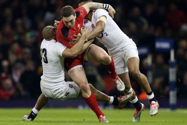 George North is tackled by England's Anthony Watson and Jonathan Joseph during the Six Nations opener at the Millennium Stadium on Friday night