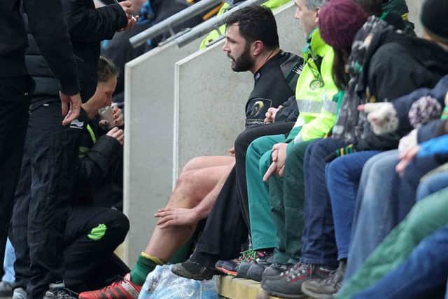 SITTING IT OUT - Alex Corbisiero receives treatment after being forced off the pitch on Saturday (Picture: Sharon Lucey)