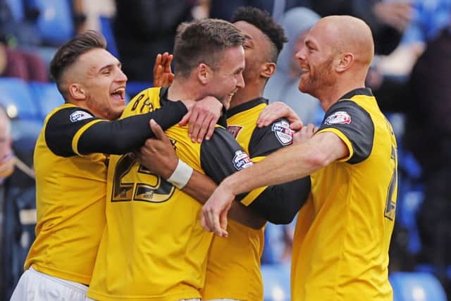 GET IN THERE - the Cobblers players celebrate Joel Byrom's strike at Shrewsbury (Picture: Kirsty Edmonds)