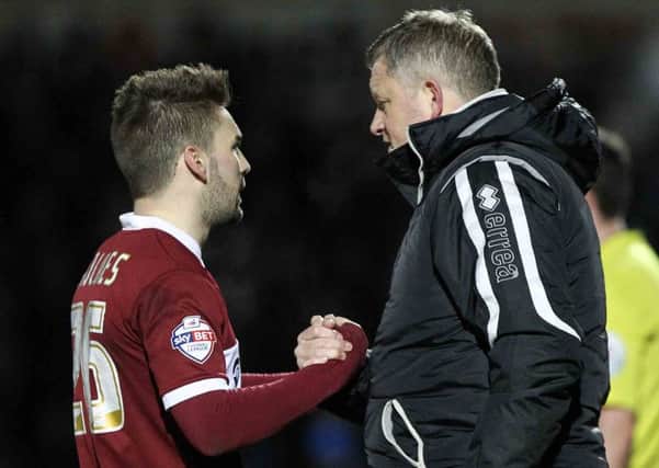 WELL PLAYED - Cobblers boss Chris Wilder congratulates Ricky Holmes on his performance in the win over Portsmouth (Pictures: Sharon Lucey)