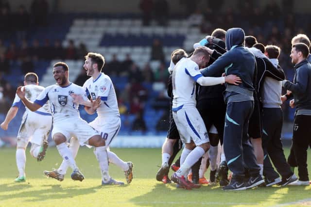 LAST-GASP WINNER - Bury's players and staff celebrate their second goal against the Cobblers (Pictures: Kirsty Edmonds)
