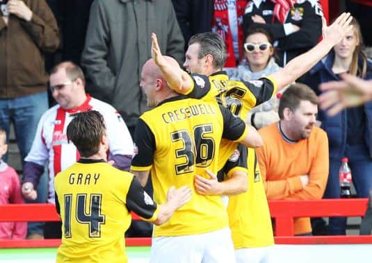 CHANCE MISSED - Ryan Cresswell and James Gray celebrate with Zander Diamond after the Cobblers goal at Stevenage (Picture: Sharon Lucey)
