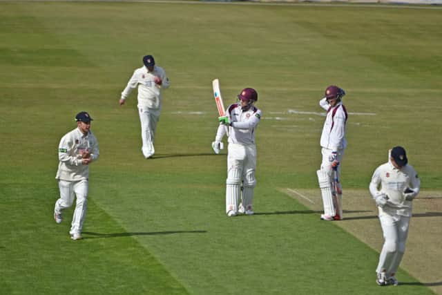 Adam Rossington raises his bat after reaching a half-century for Northamptonshire on the first day of the new LV County Championship Division Two season against Gloucestershire at the County Ground. Pictures by Dave Ikin