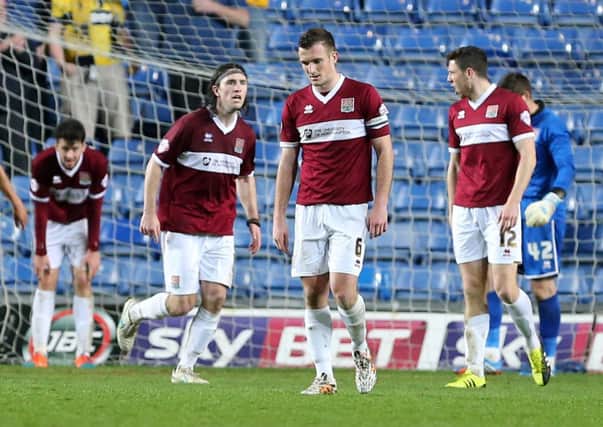 BITTER PILL TO SWALLOW - the Cobblers players show their disappointment after Oxford's late equaliser (Pictures: Kirsty Edmonds)