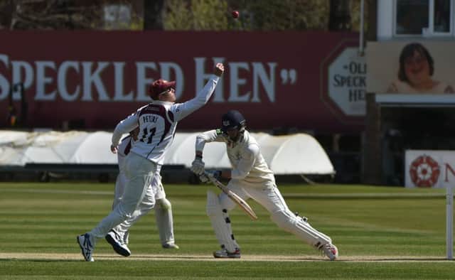 Chris Dent pushes forward and Stephen Peters fields during day four of Northamptonshire LV= County Championship clash with Gloucestershire