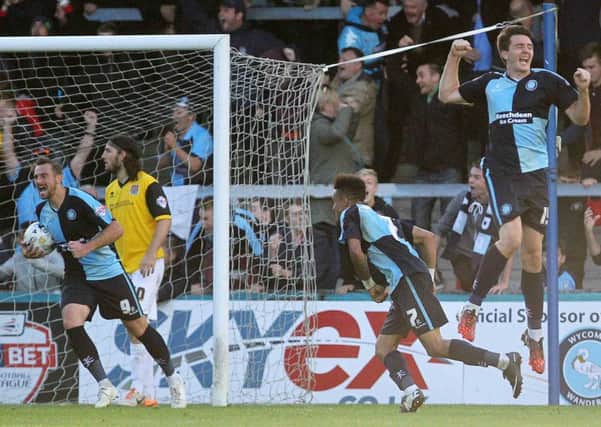 LATE HEARTBREAK - Wycombe Wanderers' players celebrate their last-gasp equaliser against the Cobblers back in October