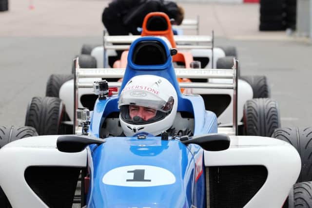 Madness driving challenge at Silverstone Circuit. Suggs is pictured in the blue car Silverstone 1. NNL-151105-101346009