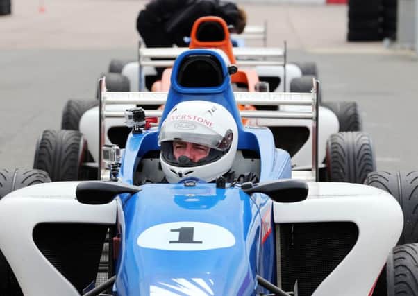 Madness driving challenge at Silverstone Circuit. Suggs is pictured in the blue car Silverstone 1. NNL-151105-101346009