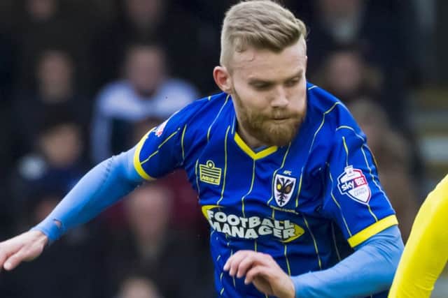 Alfie Potter in action for AFC Wimbledon in March