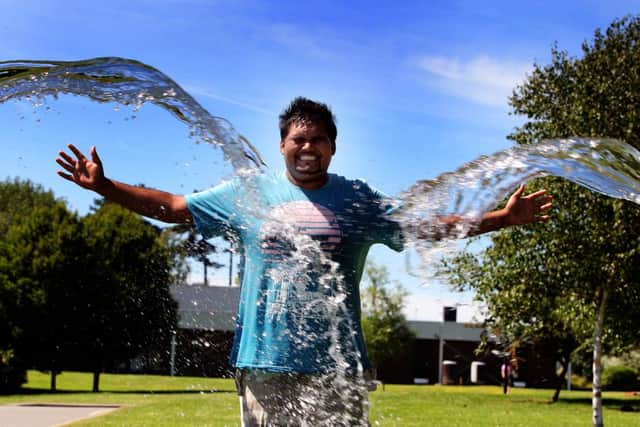 Eamon Lindsell from Northampton University Student Union, cooling off in the hot weather.