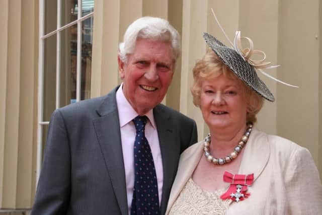 Sally Smith pictured with her husband, Graham, in the Palace Courtyard after receiving her MBE