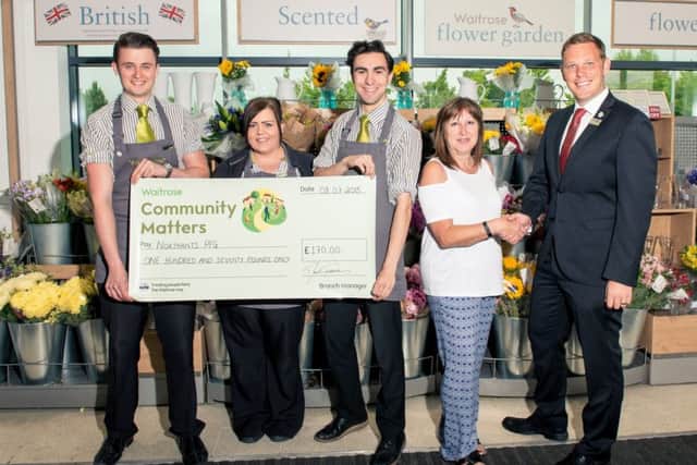 NPFGs Treasurer, Jane Marriott, thanking Darrell Trevelean, Department Manager at Waitrose, Wootton for their support
