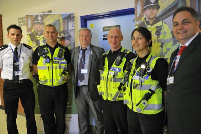 Police officers and hospital directors outside the new community hub