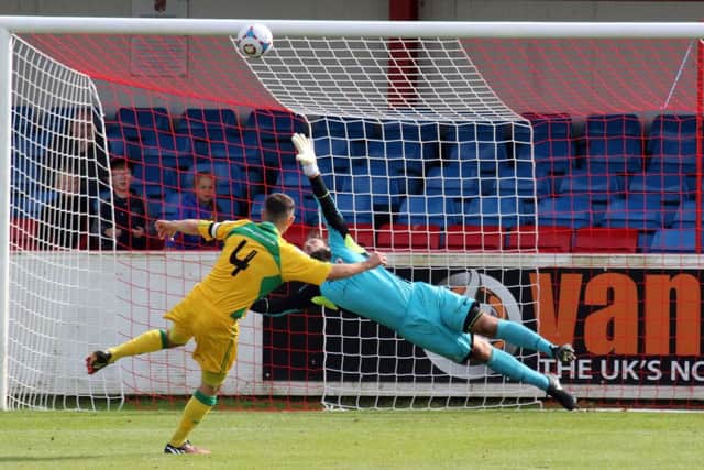 Brackley Town keeper Dan Crane saves Liam King's penalty but North Ferriby United still won 4-2 at St James Park