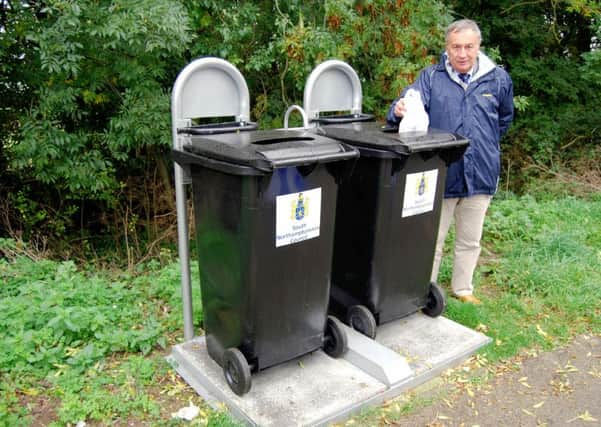 Councillor Dermot Bambridge, South Northants Council's portfolio for environmental services with one of the new bin units installed in an A43 lay-by near Croughton