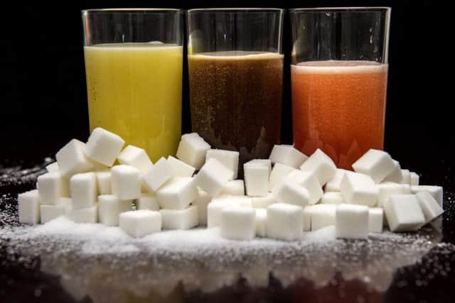 Carbonated drinks surrounded by sugar cubes, as Dr Alison Tedstone, director of diet and obesity for Public Health England (PHE), said that an official review has found a sugar tax could be effective at curbing childhood obesity.